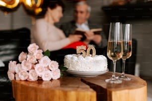 a table with a cake and two glasses of wine