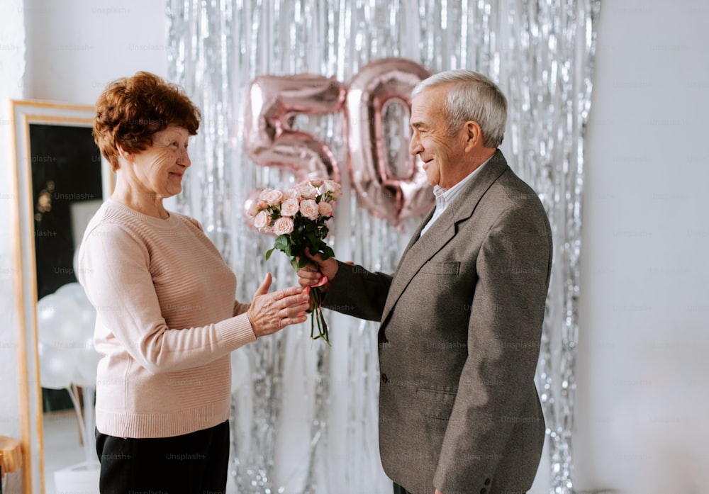 a man giving a woman a bouquet of flowers