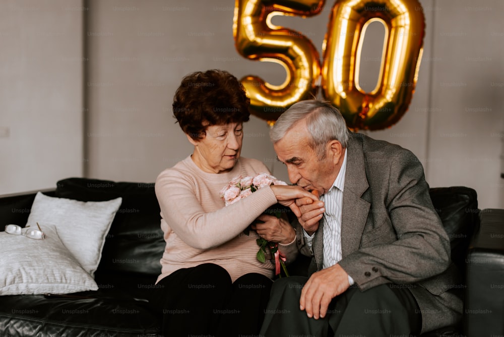 a man and woman sitting on a couch next to each other