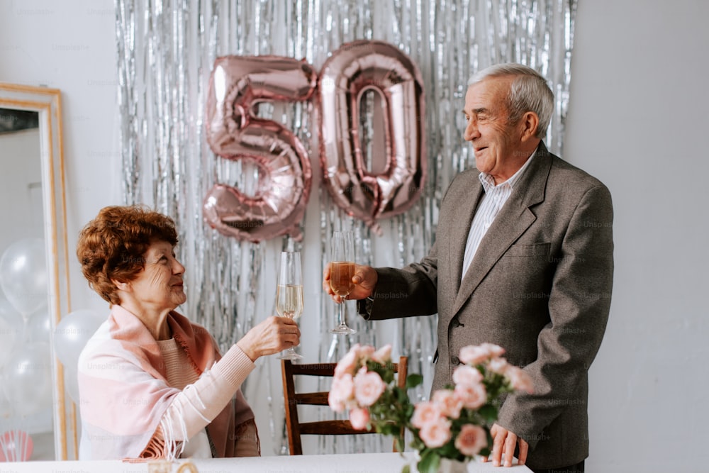 a man and woman toasting each other at a table