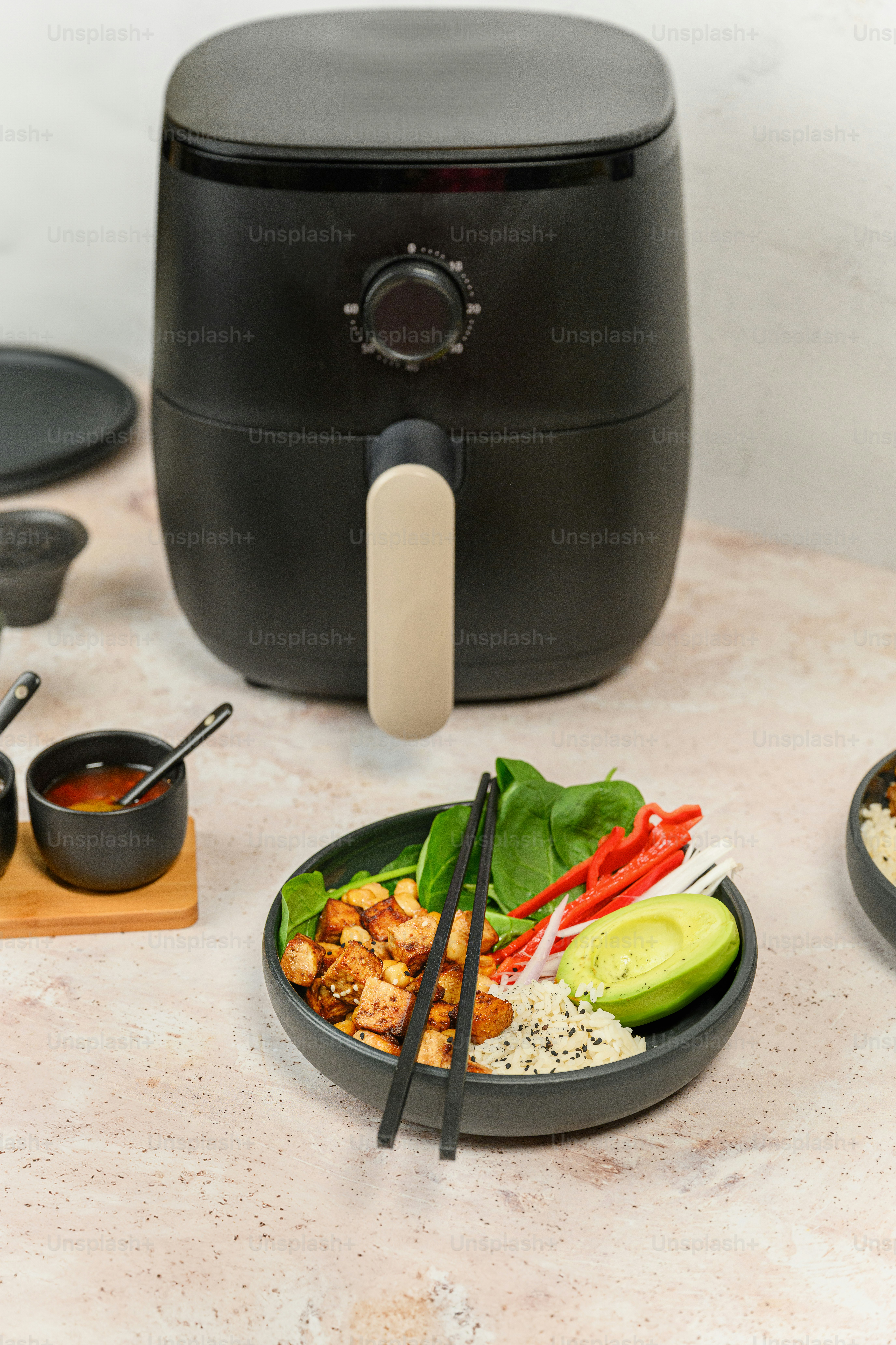 a bowl of food with chopsticks on a table
