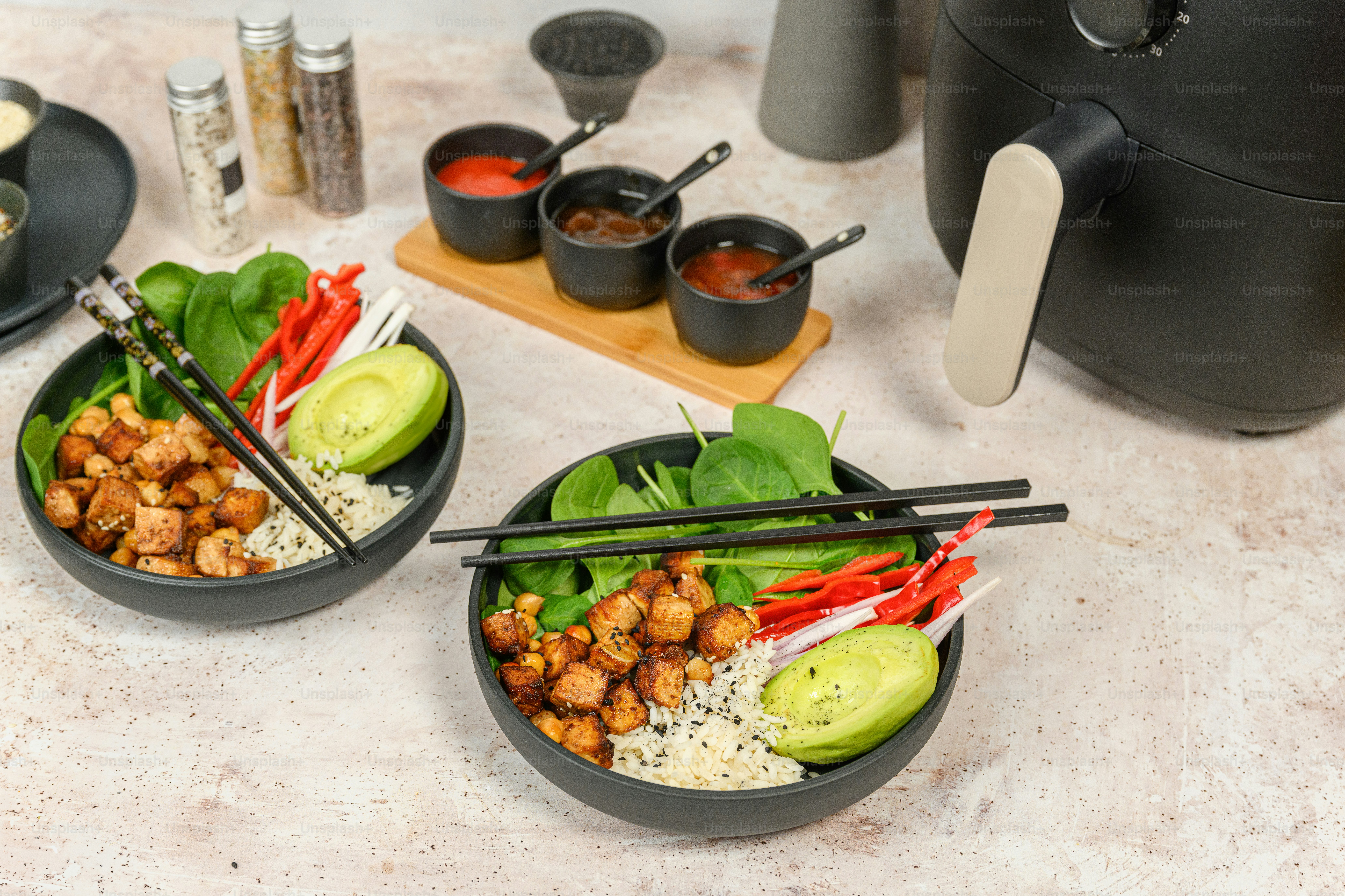a table topped with bowls of food and chopsticks