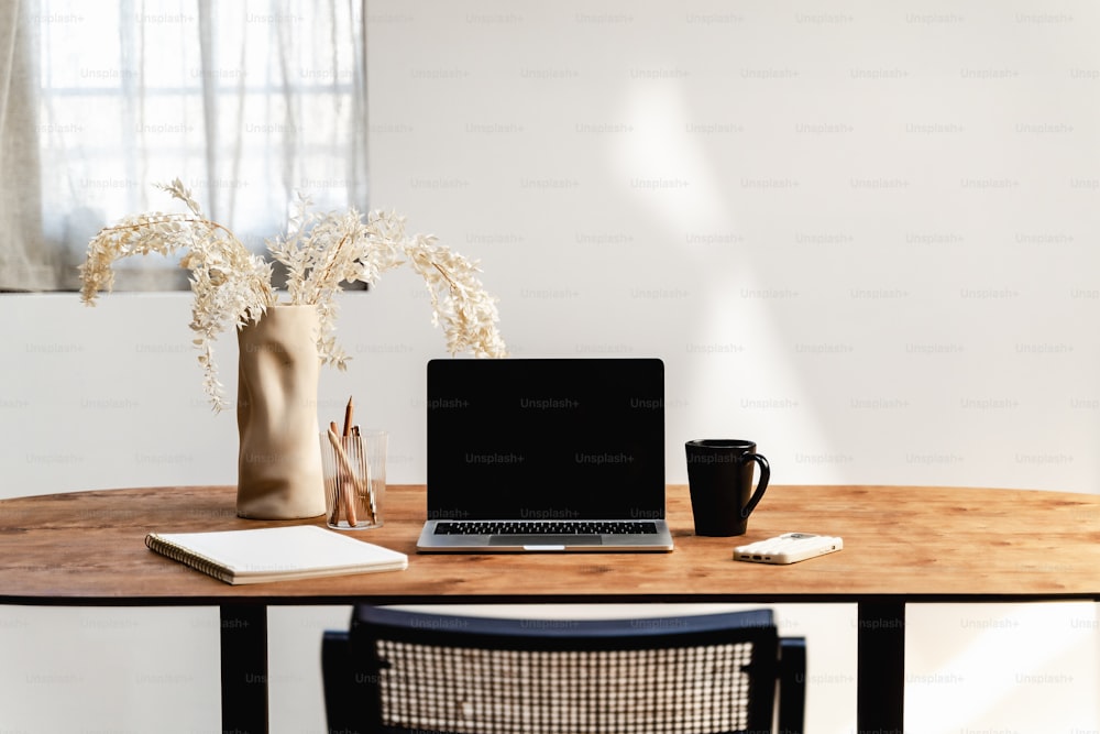 a laptop computer sitting on top of a wooden table