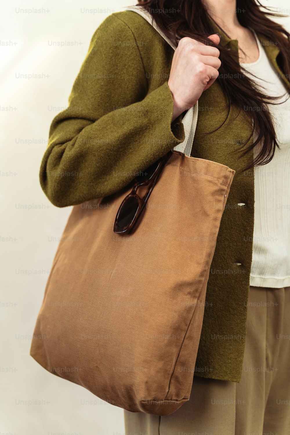 a woman holding a brown bag in her hands