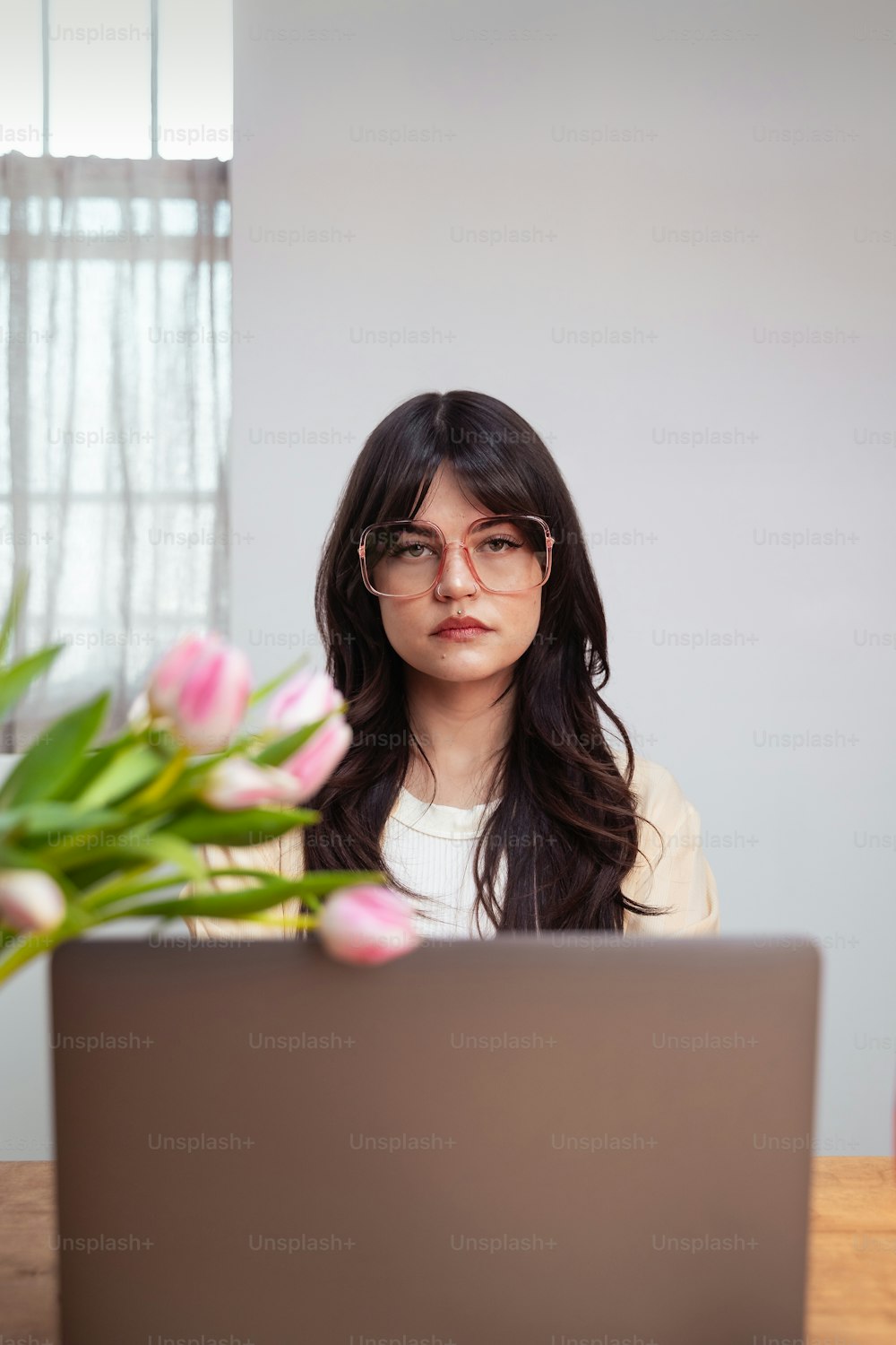 a woman sitting in front of a laptop computer