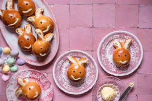 a table topped with plates filled with bunnies covered in icing