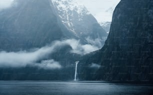 a waterfall in the middle of a body of water