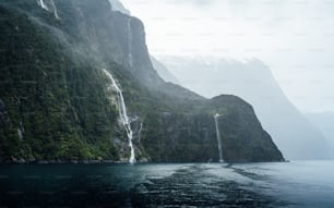 a waterfall in the middle of a body of water