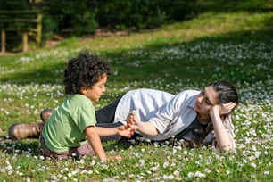 a woman laying on the ground next to a child