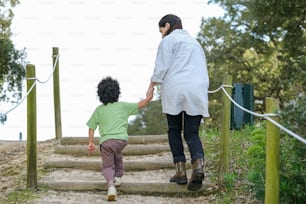 a woman walking down a set of stairs with a child