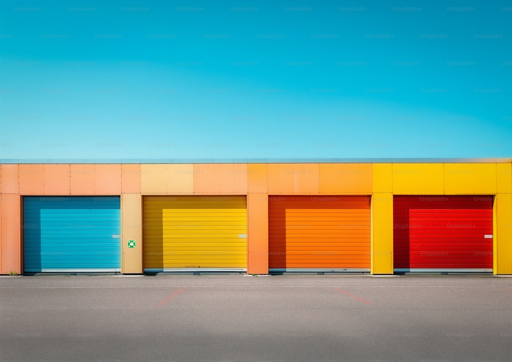 a row of colorful garage doors in front of a building