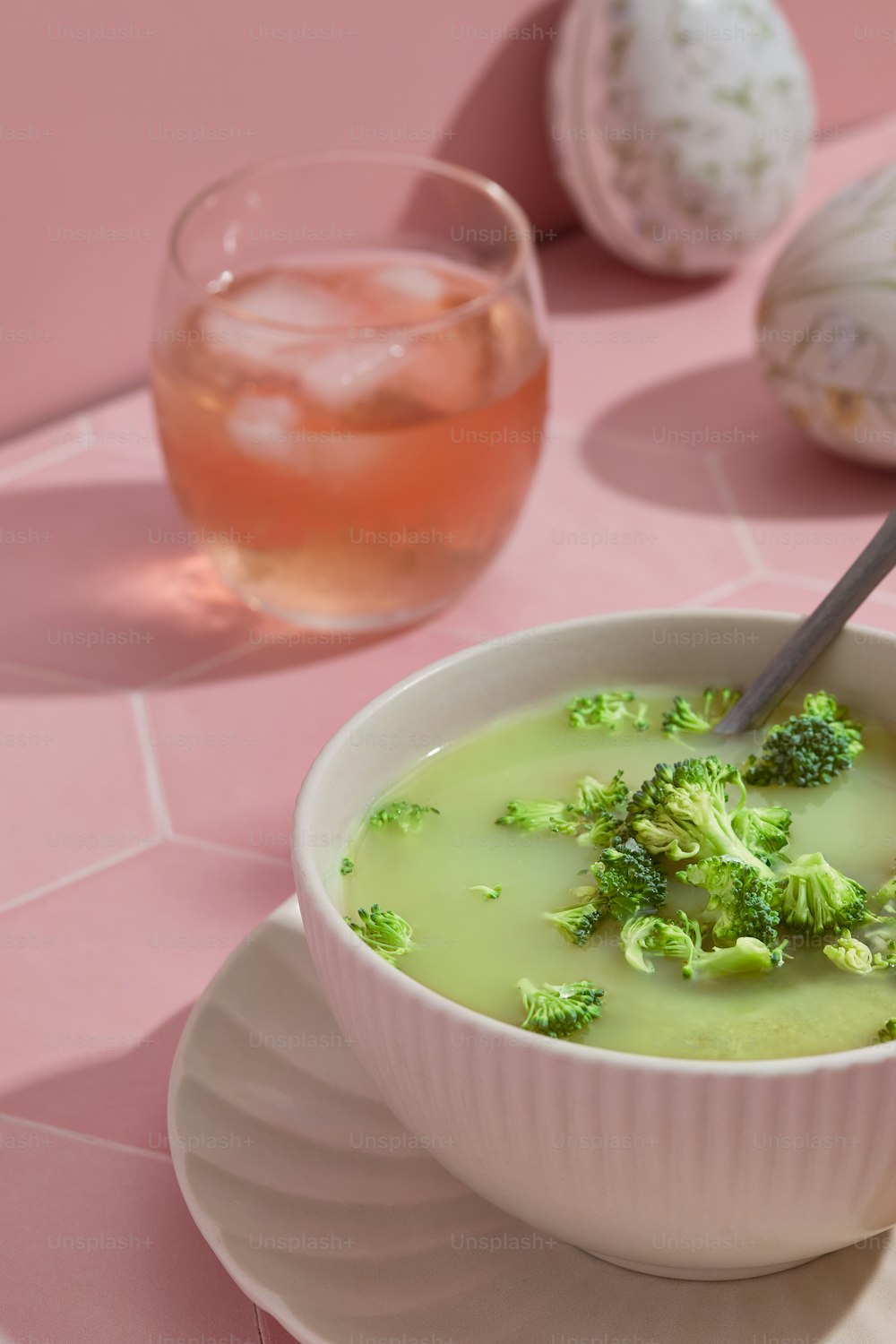a bowl of broccoli soup with a spoon in it