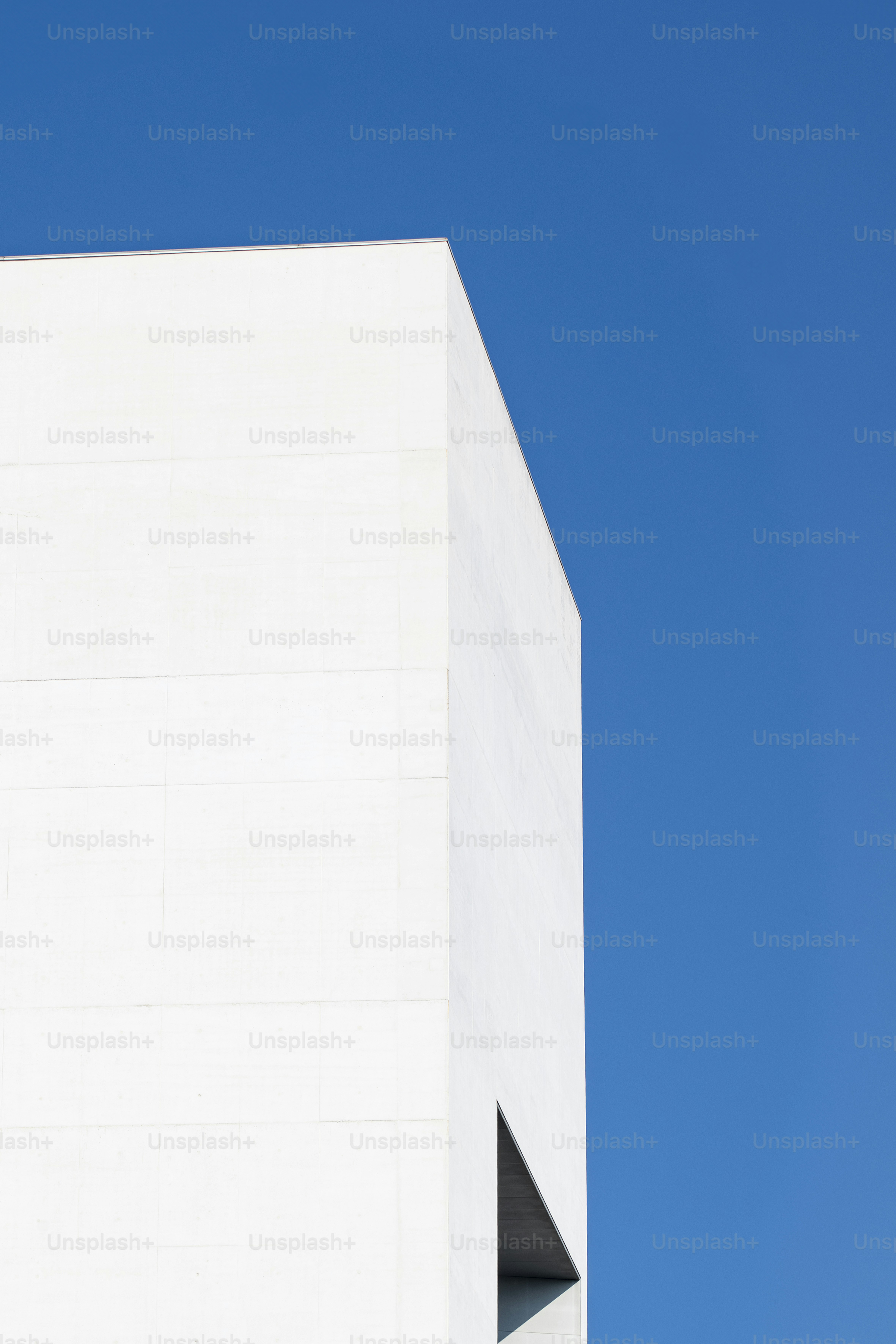 a clock on the side of a white building