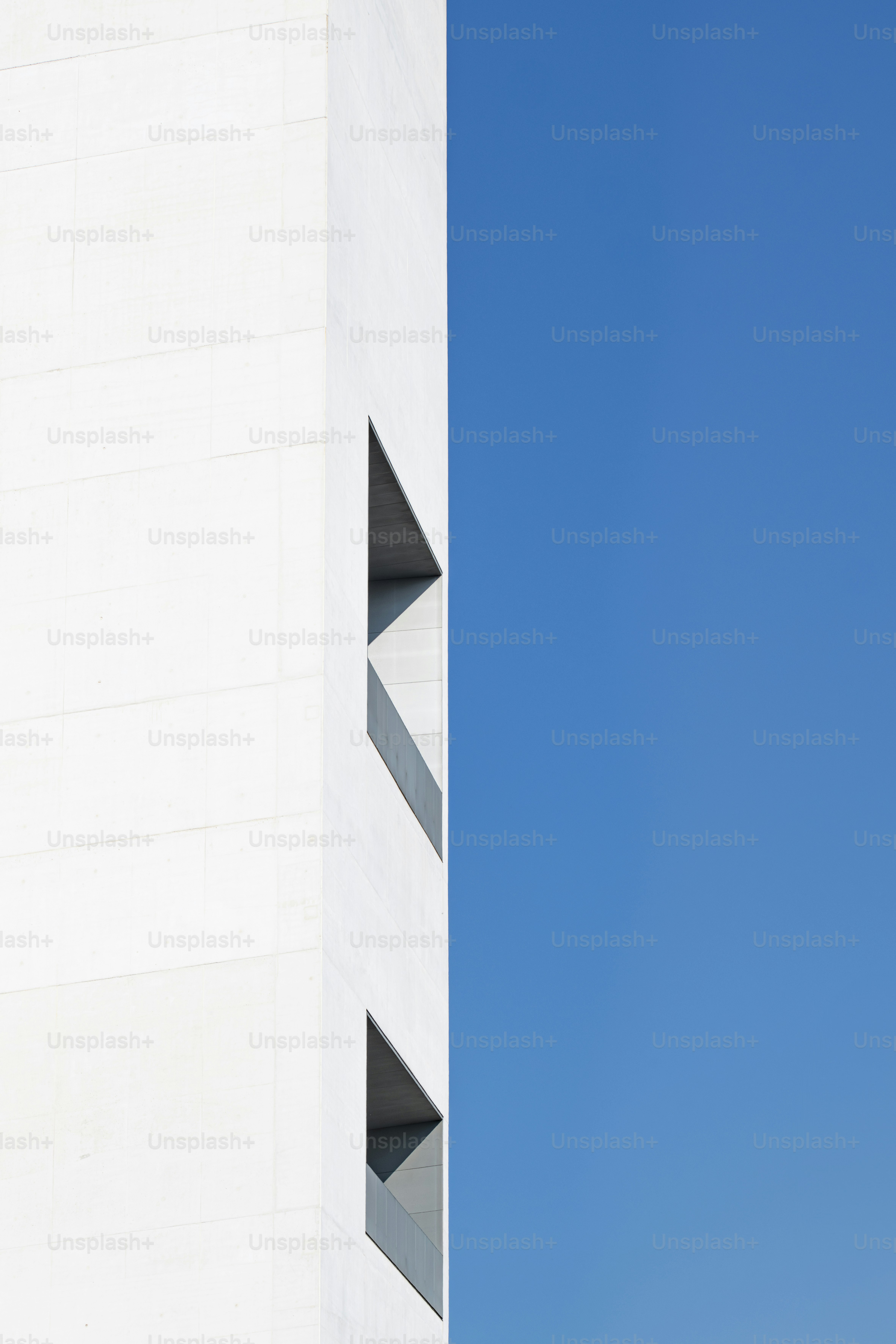 an airplane flying in the sky over a building