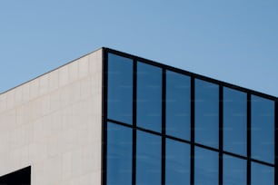 a plane flying over a building with a sky background