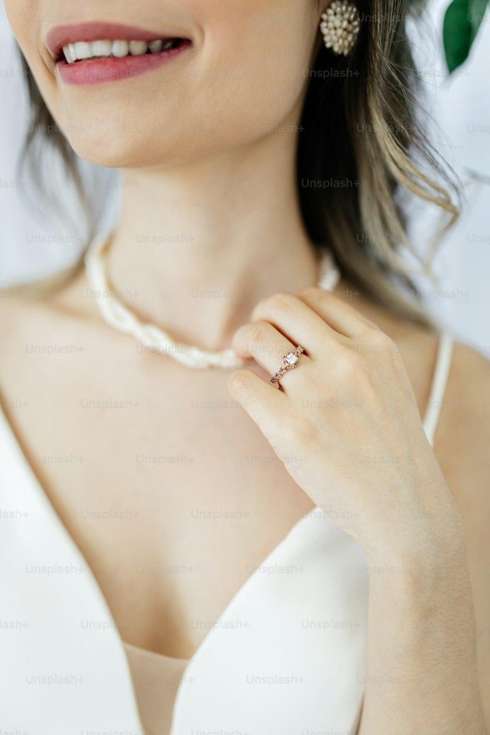 a woman wearing a necklace and a ring