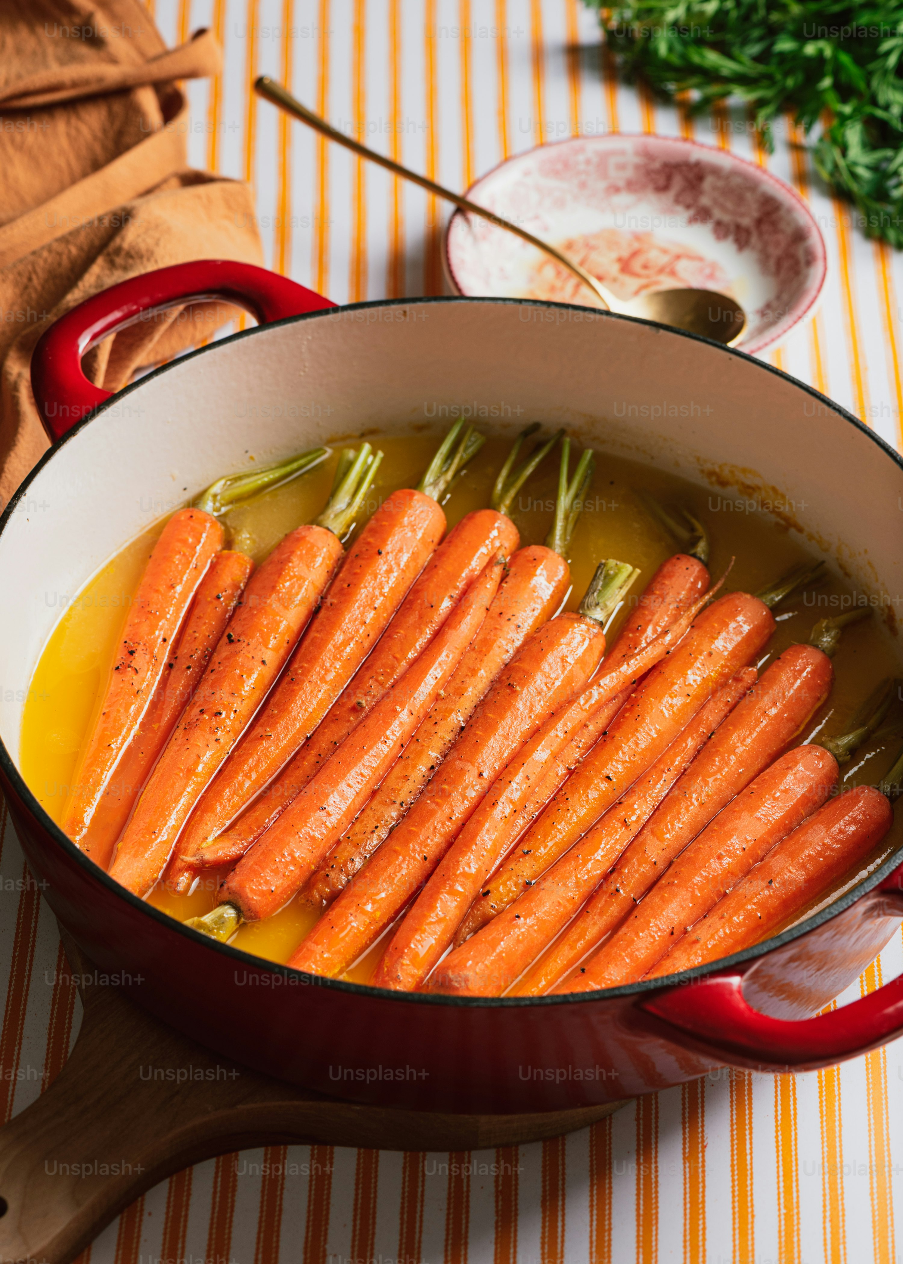 a pot filled with carrots sitting on top of a table