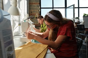 two women working on a sewing project in a sewing studio