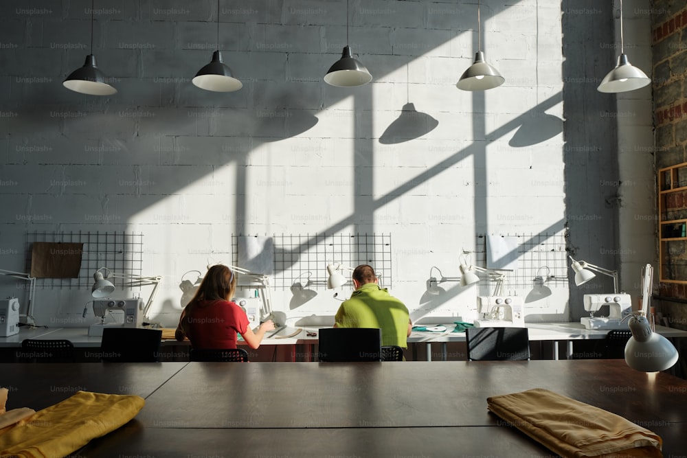 a couple of people sitting at a table in a room