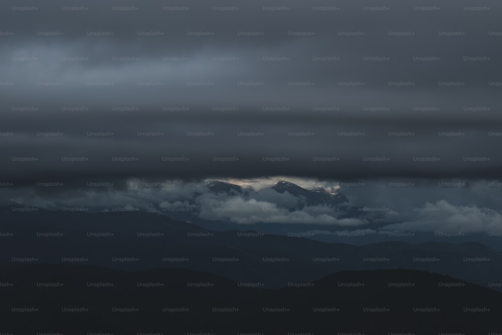 a view of a mountain range under a cloudy sky