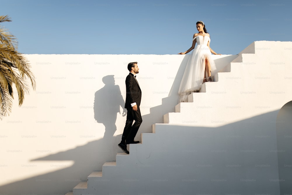 a man and a woman standing on a set of stairs