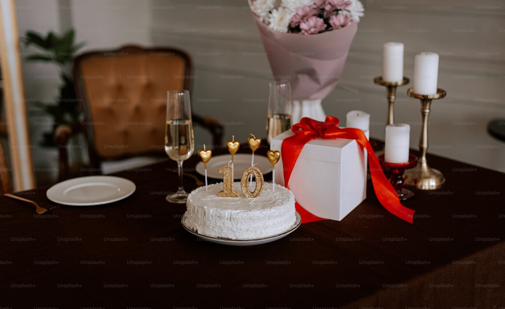 a table topped with a cake covered in white frosting