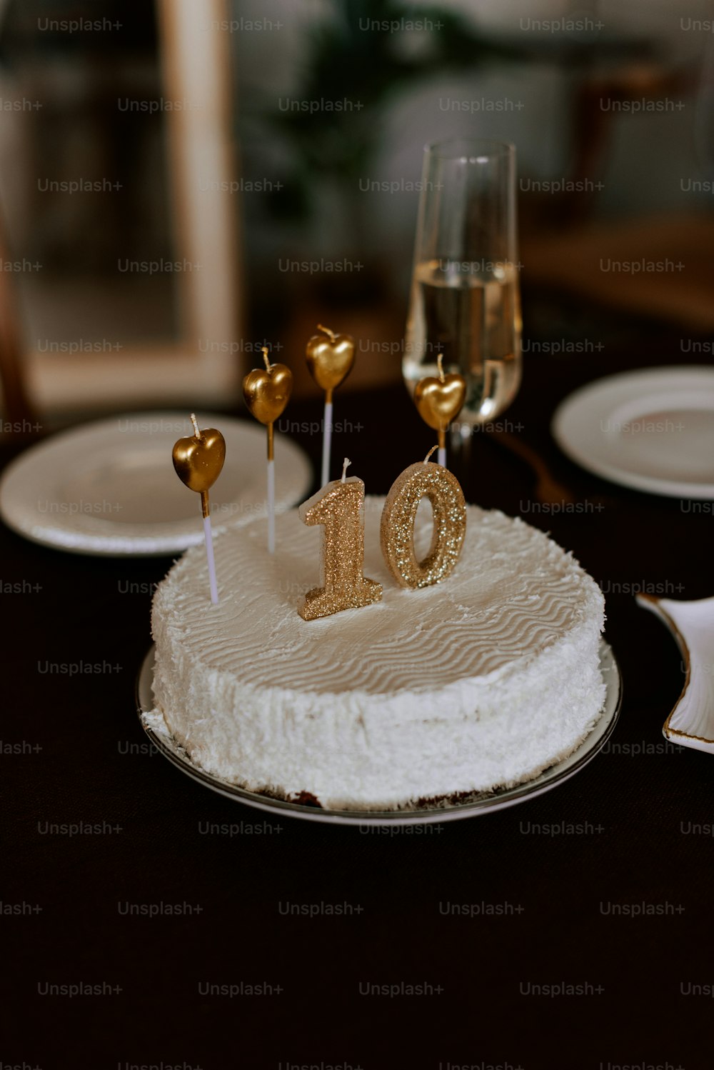 a white cake with gold decorations on a table