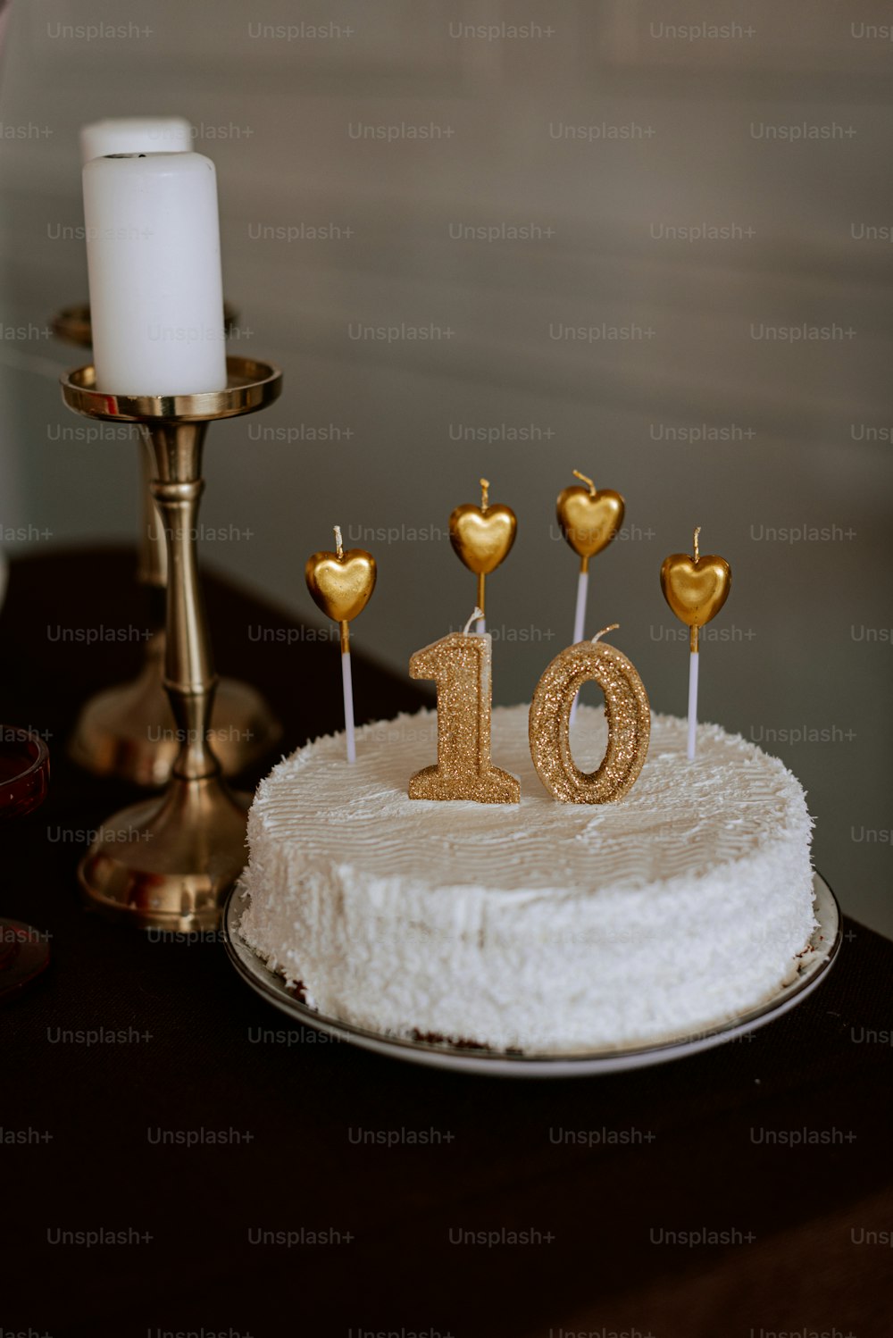 a white cake with gold hearts on top of it