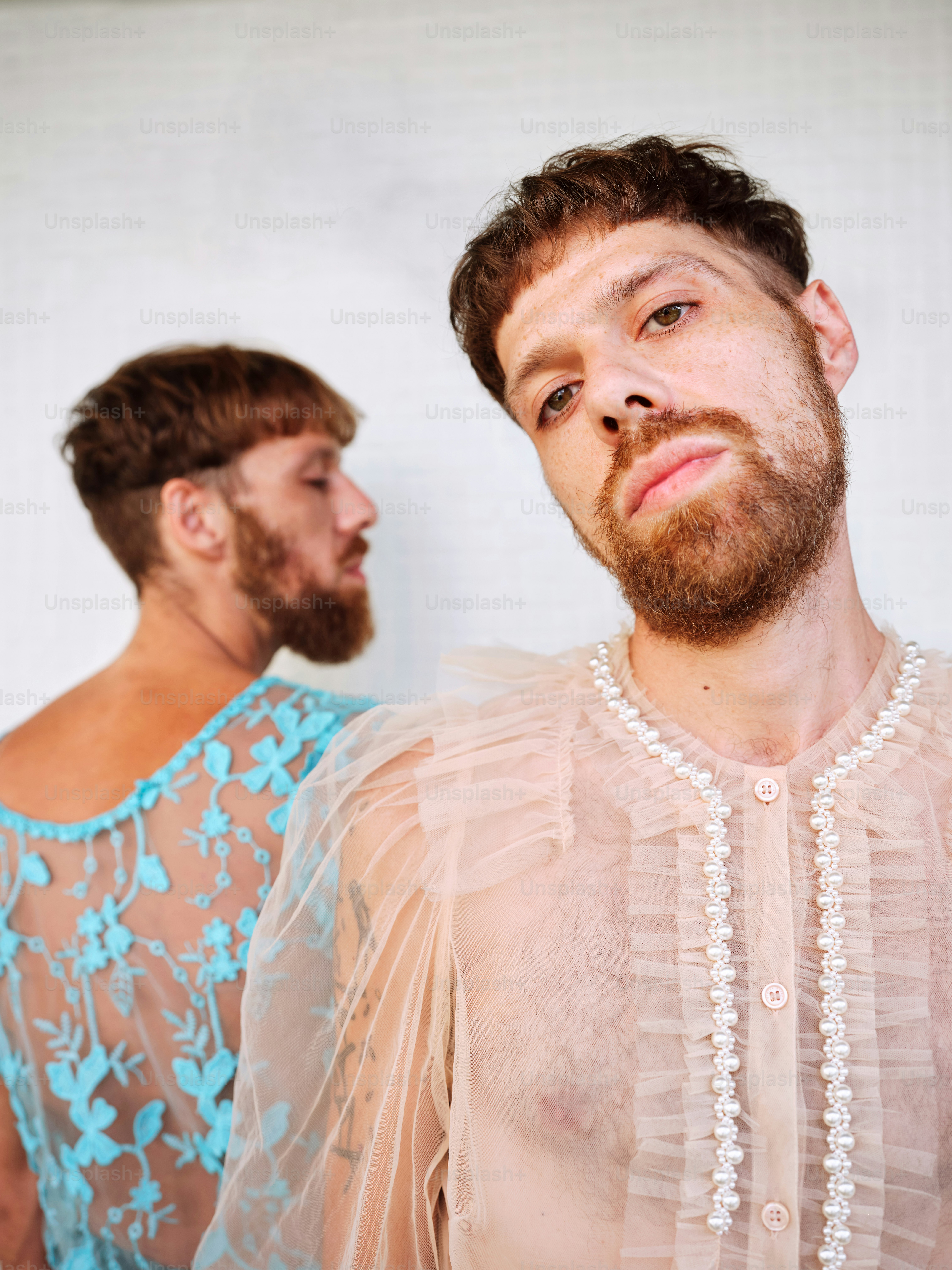 a man with a beard standing next to another man