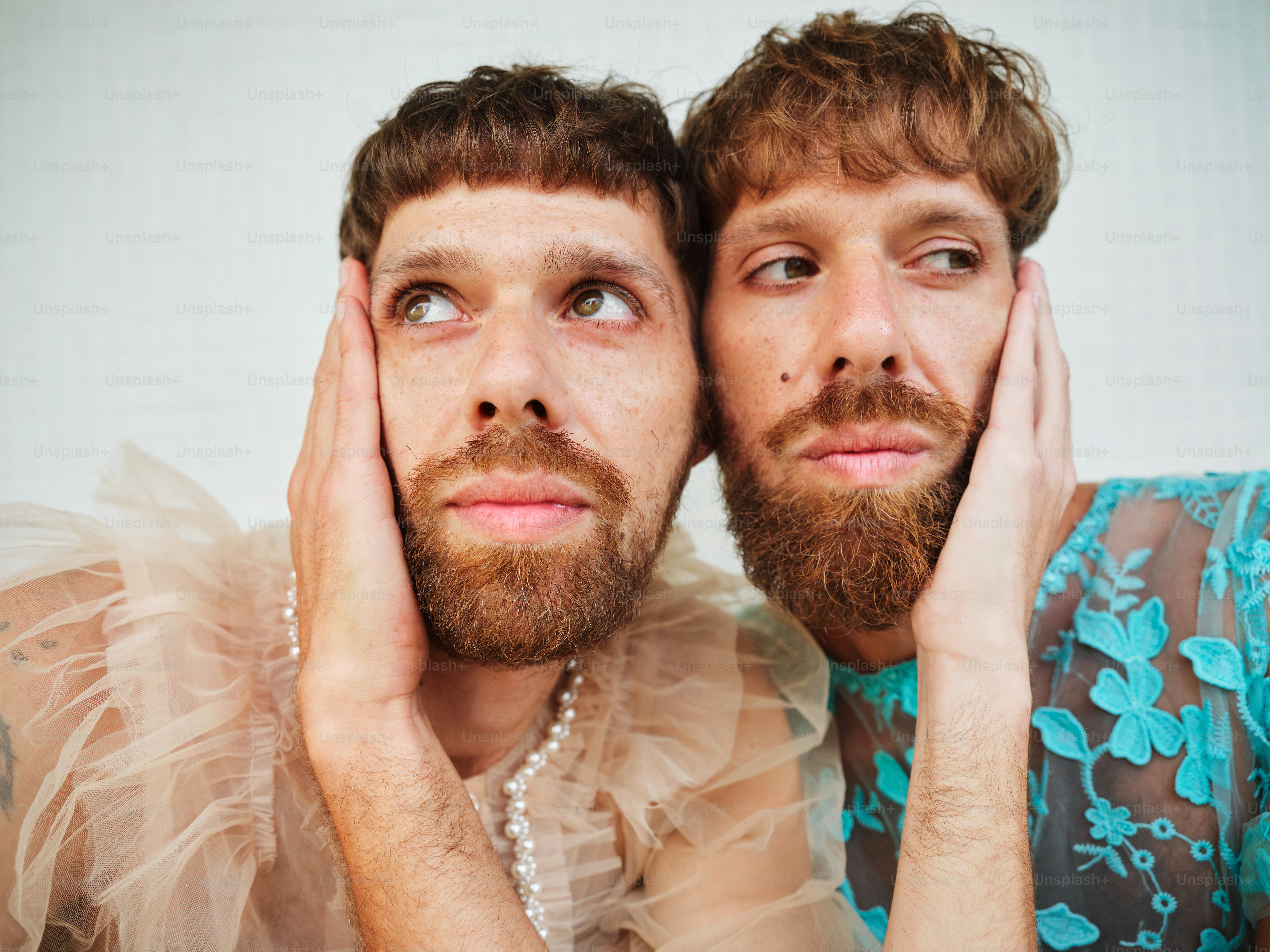 a couple of men sitting next to each other