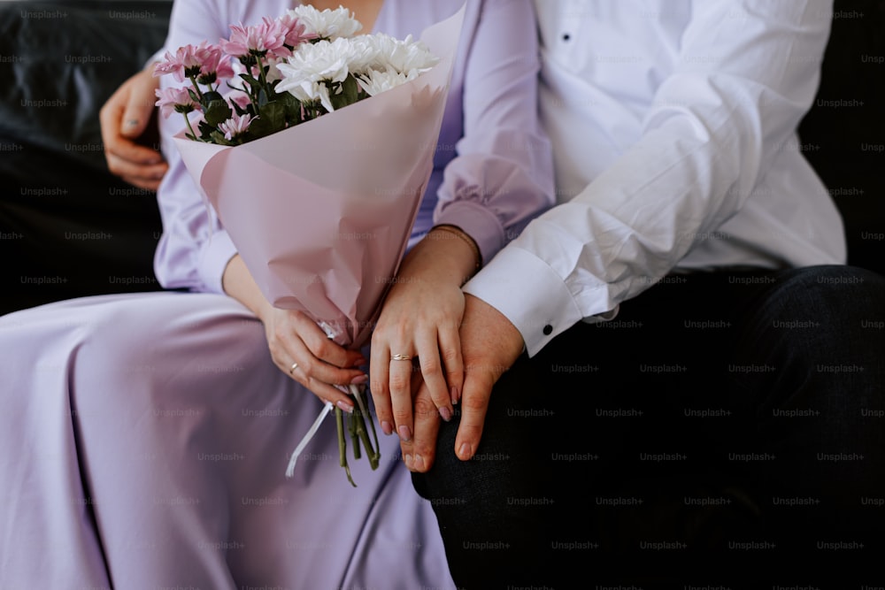 a man holding a bouquet of flowers next to a woman