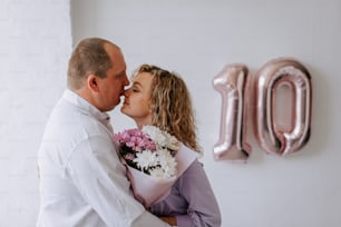 a man and a woman kissing in front of the number 10