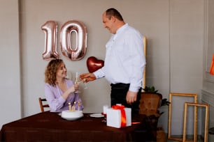 a man giving a woman a birthday cake