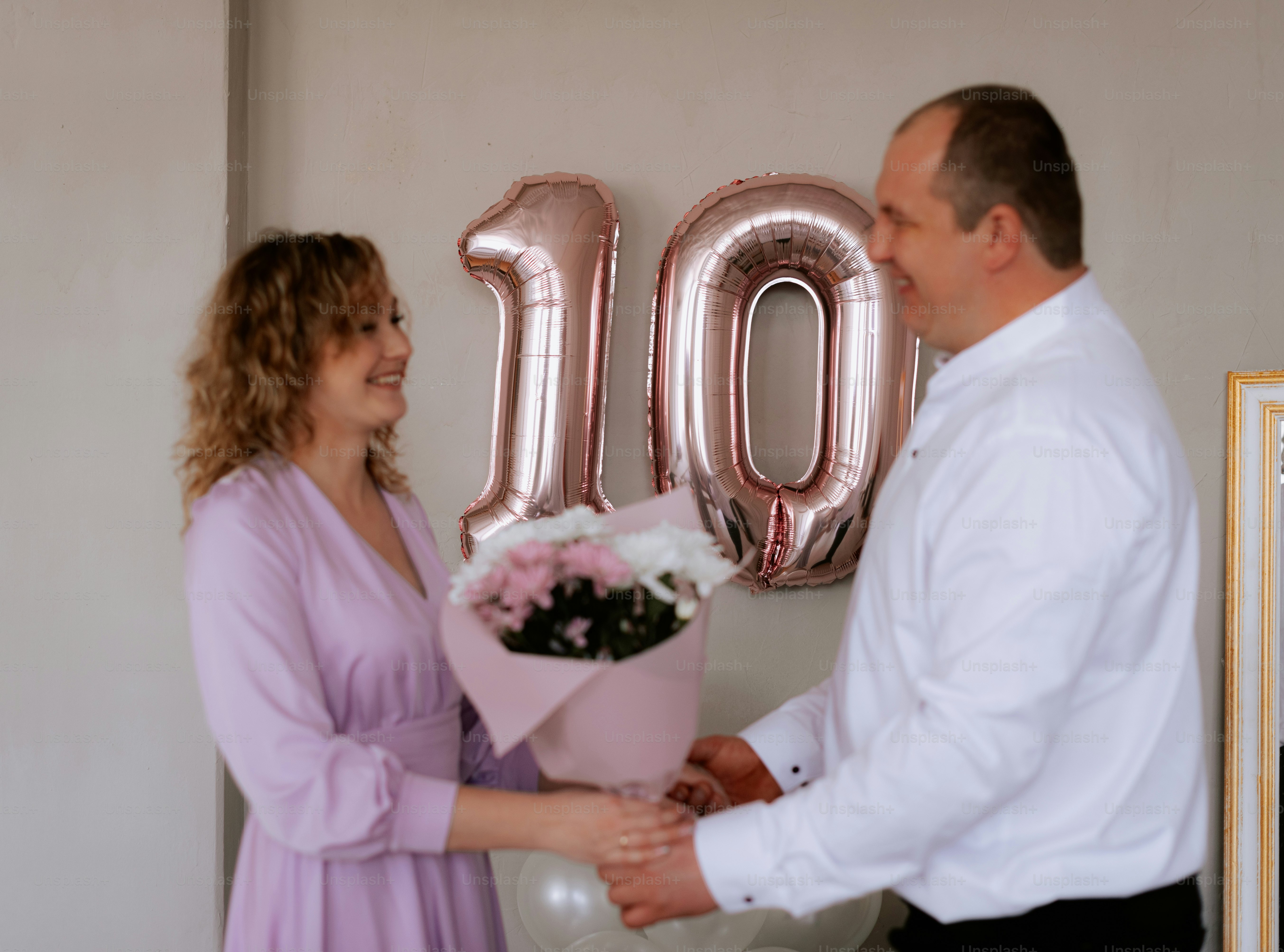 a man and a woman holding a bouquet of flowers
