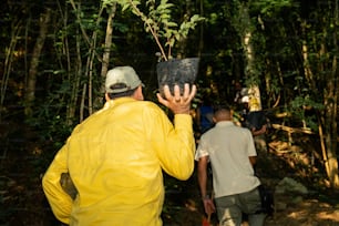 a group of people walking through a forest