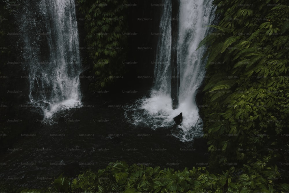 a man standing in the middle of a waterfall