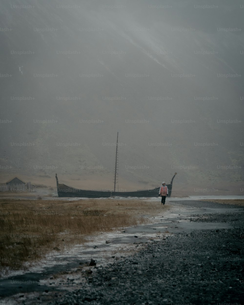 a boat sitting on top of a dry grass field