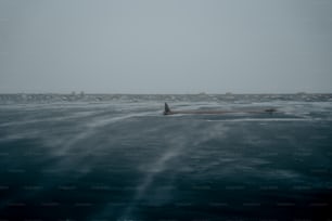 a large body of water with a boat in the distance