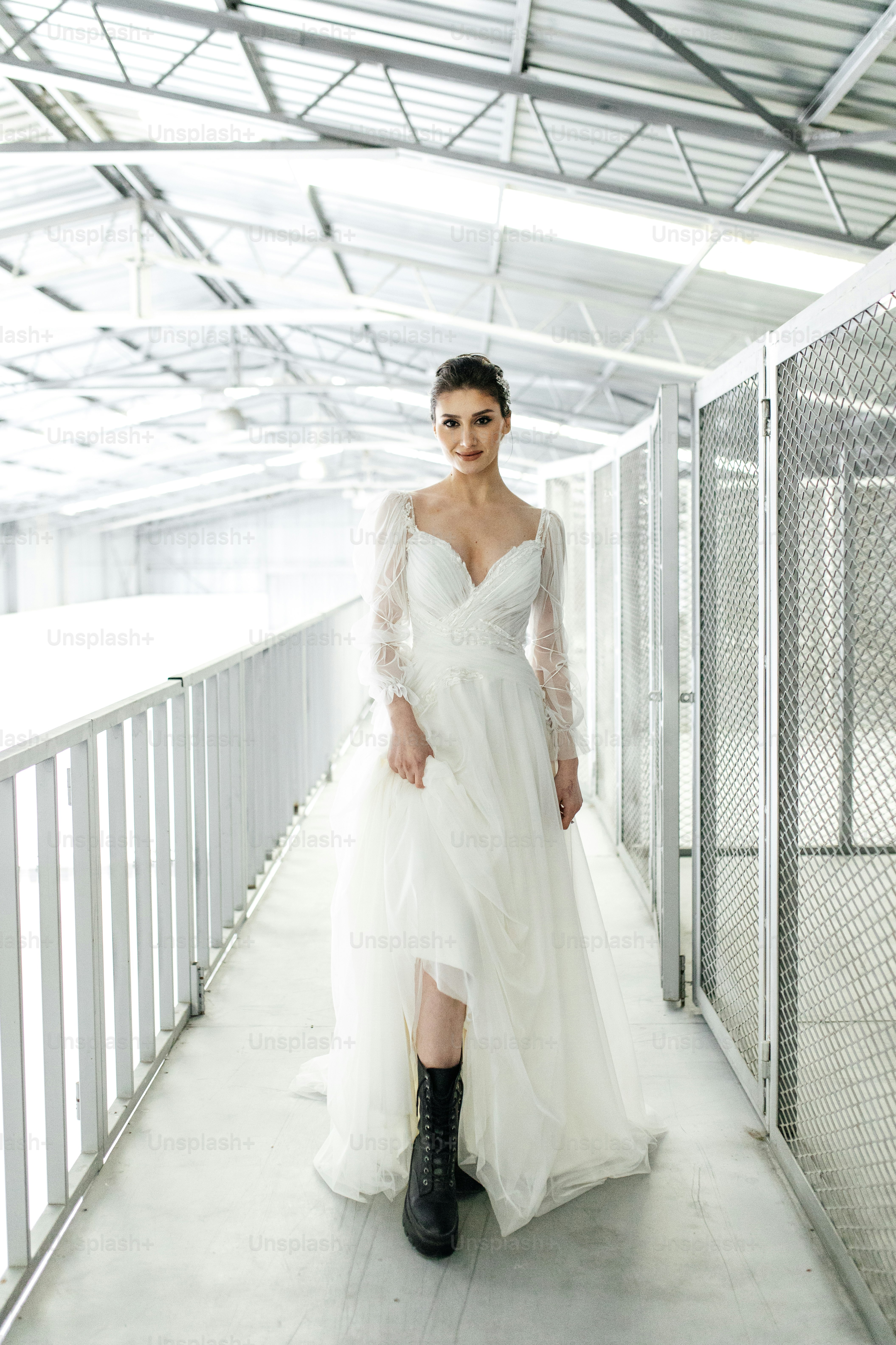 A woman in a white dress and black boots photo  Wedding Image on Unsplash