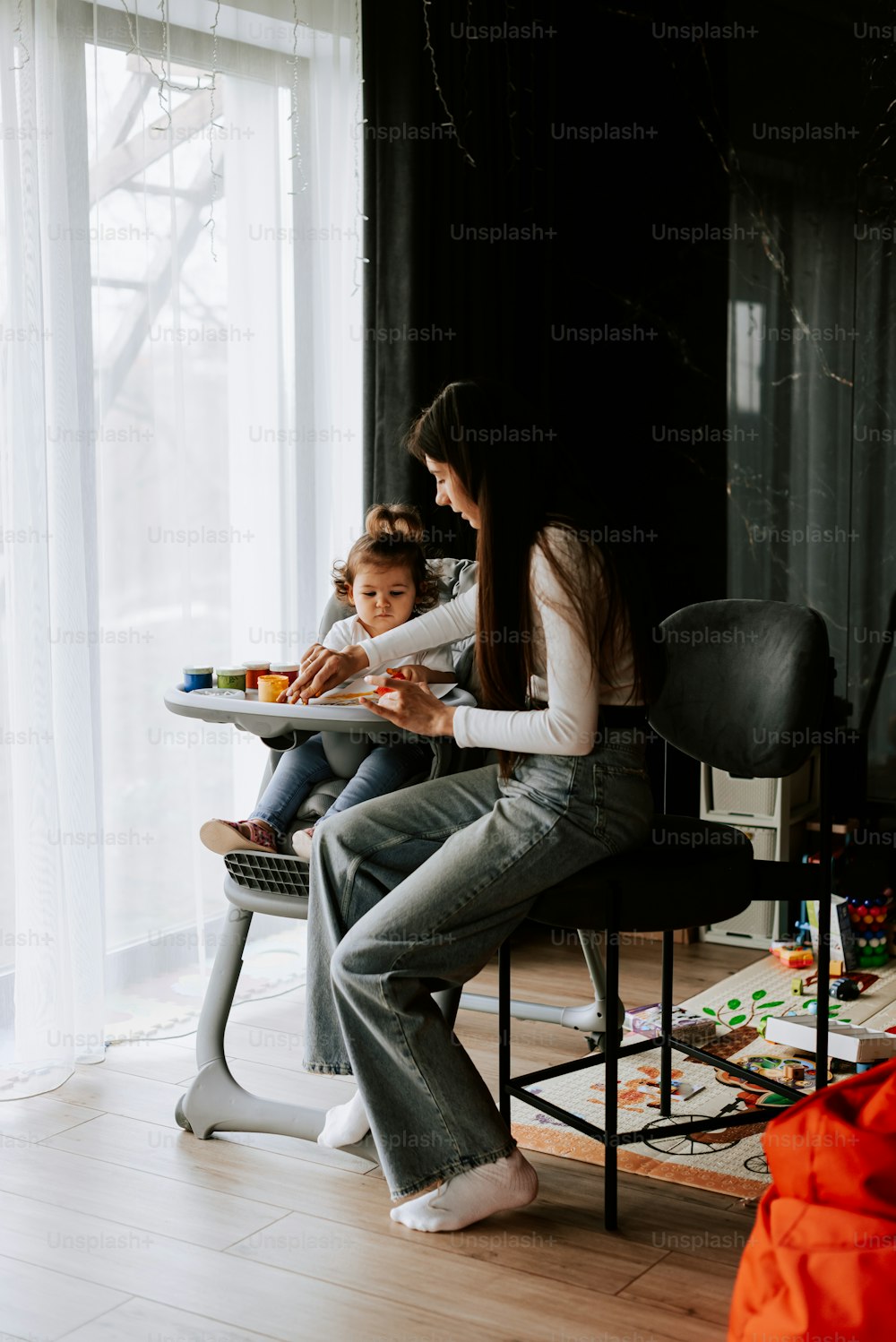 a woman and a child sitting at a table