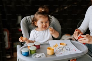 유아용 의자에 앉아 음식을 먹는 아기