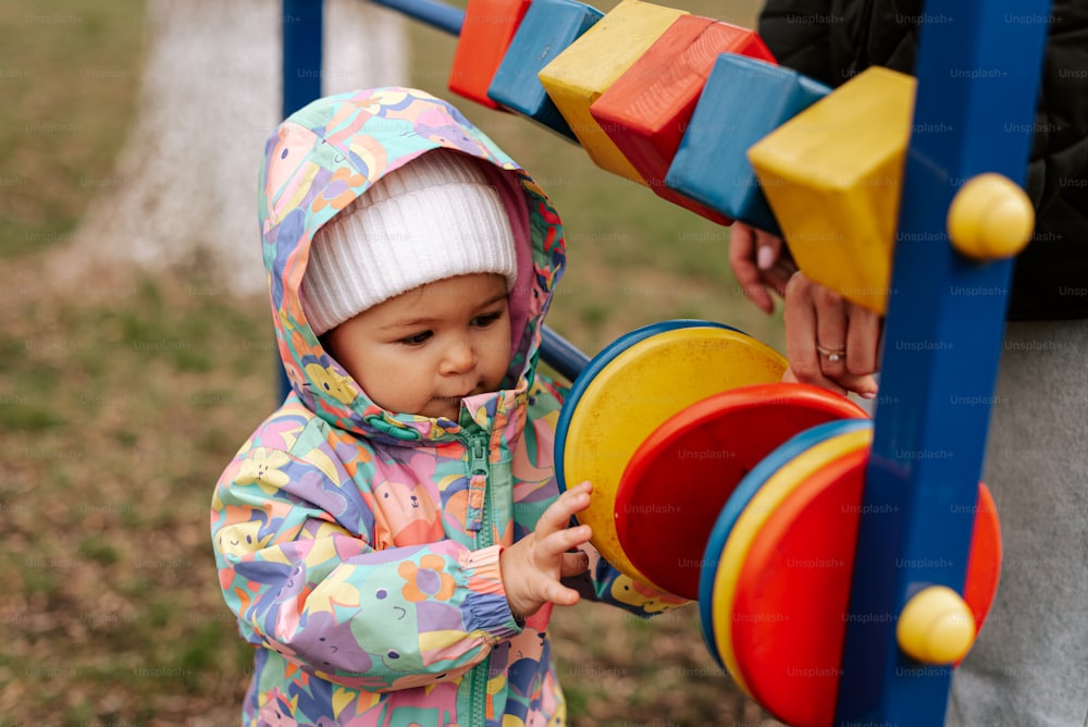 a toddler playing with a toy in a park
