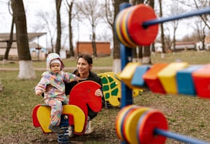 a woman and a child playing in a park