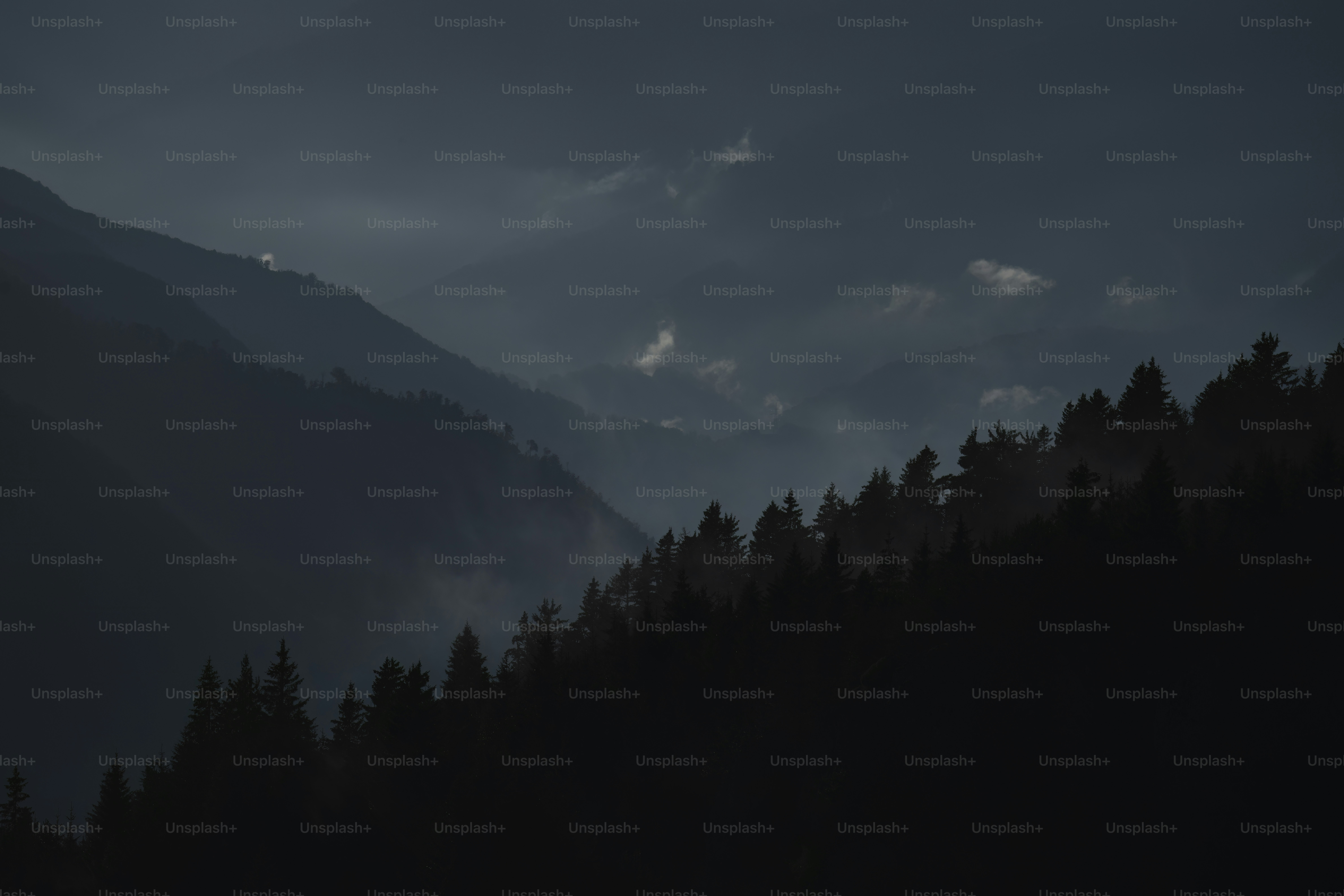 a black and white photo of a mountain range