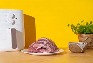 a piece of meat sitting on a plate next to a microwave