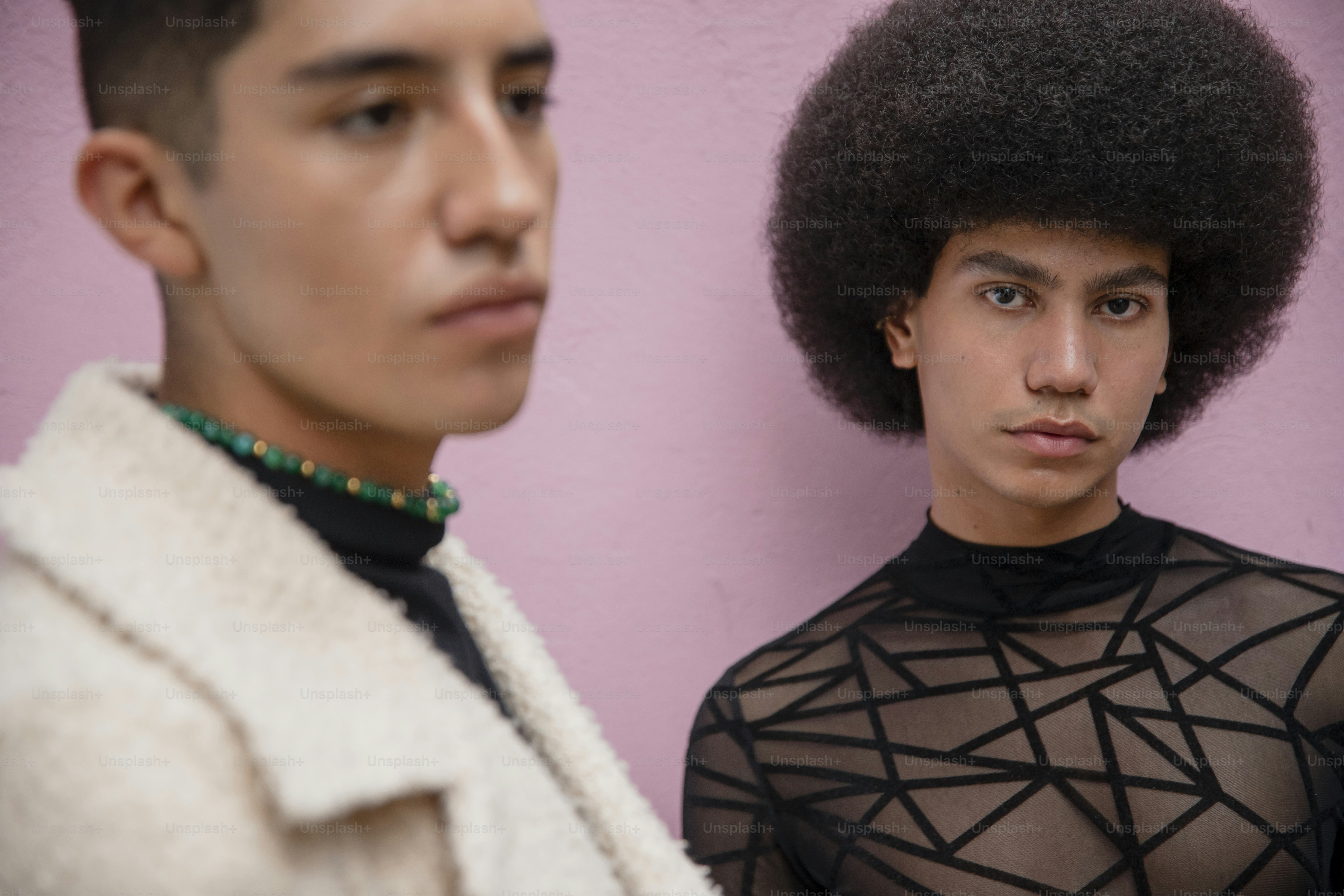a man with an afro standing next to a woman