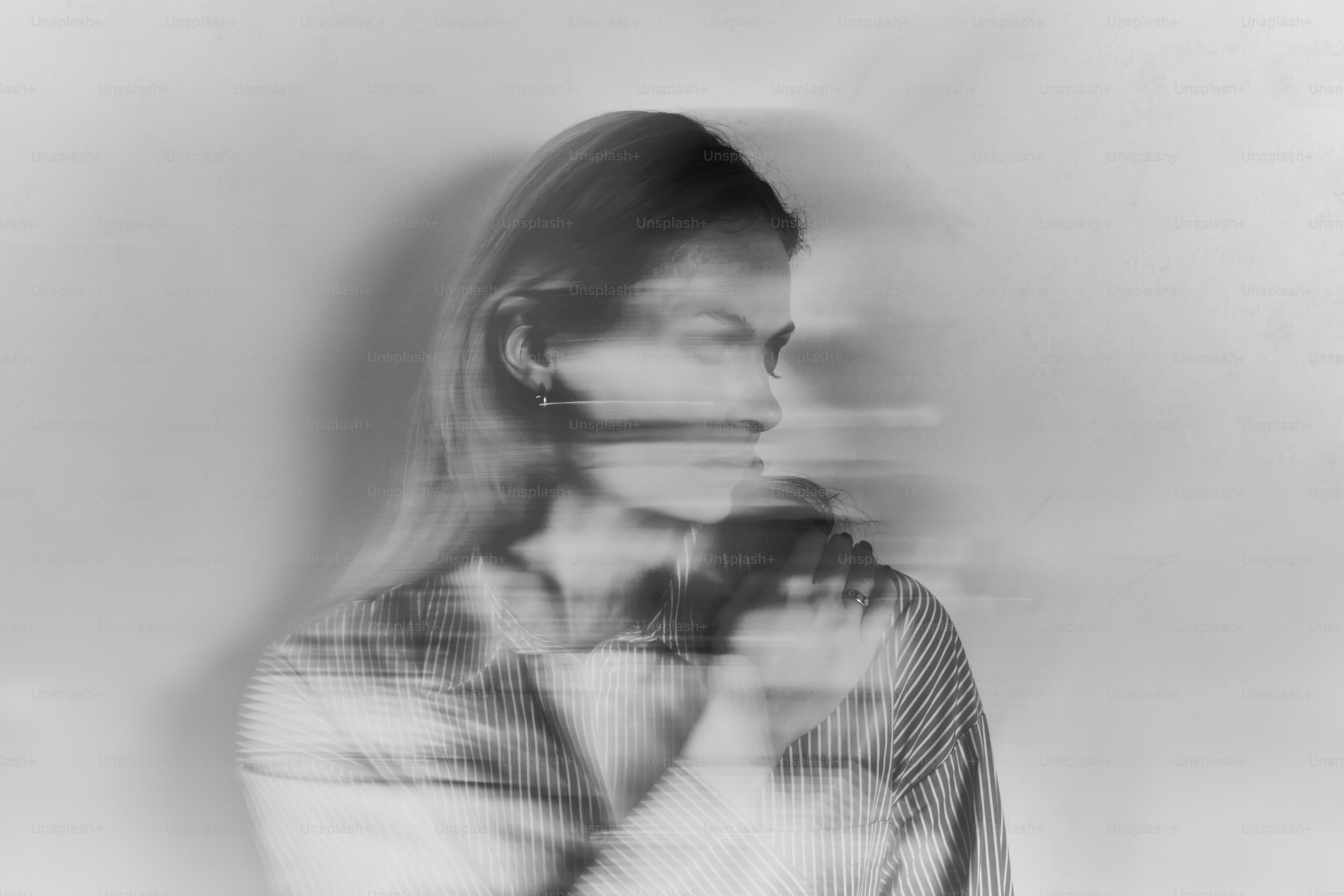 a woman standing in front of a white wall