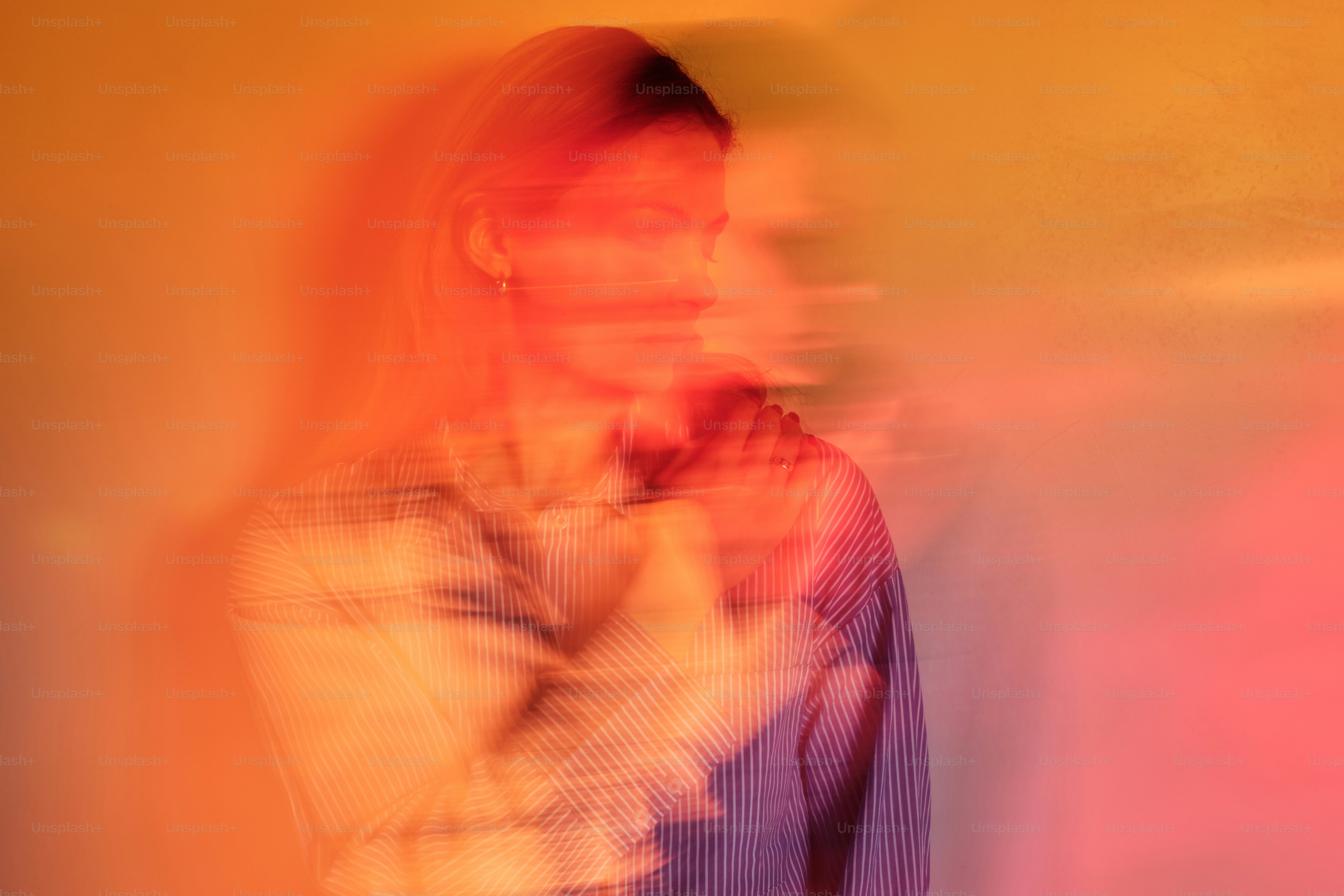 a blurry photo of a woman standing in front of a wall