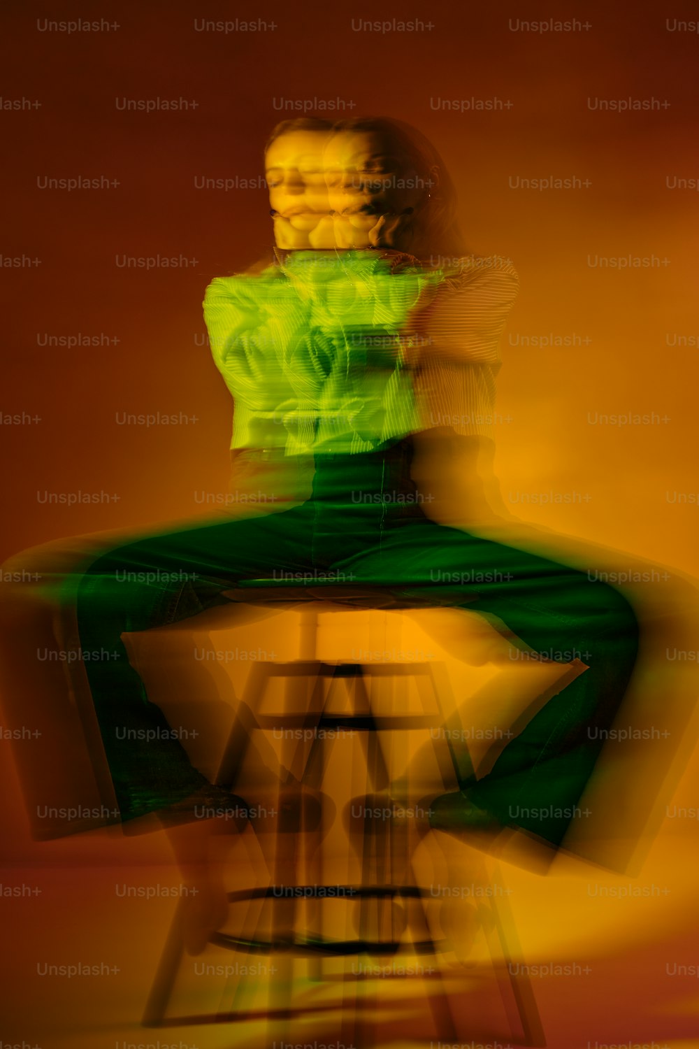 a blurry photo of a person sitting on a chair