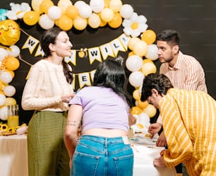 a group of people standing around a table
